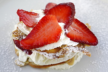 A dessert of strawberries served with cream, cream panna and almond biscuit in Monopoli, Apulia, Italy, Europe