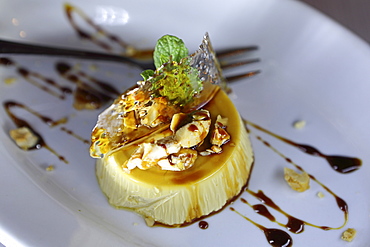 Pana cotta, a traditional Italian dessert, served with caramel and almonds, served near Castel del Monte in Apulia, Italy, Europe