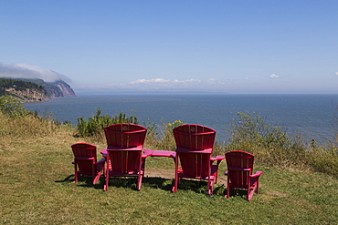 Parks Canada's red chairs at Fundy National Park, overlooking the Bay of Fundy, in New Brunswick, Canada, North America