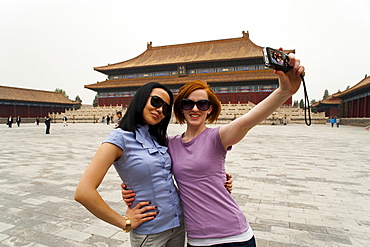 Tourists taking their own photograph in front of the Hall for Worship Of Ancestors, The Forbidden City, Beijing, China, Asia