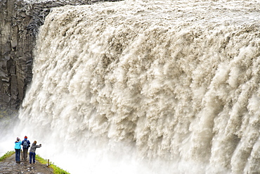 Tourists photographing Dettifoss waterfall near Myvatn in Vatnajokull National Park, northeast area, Iceland, Polar Regions