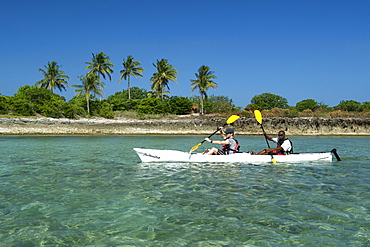 Two men kayaking off Mogundula island in the Quirimbas archipelago in northern Mozambique, Indian Ocean, Africa