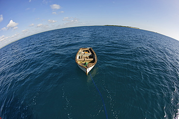 Row boat and Mogundula island in the Quirimbas archipelago in northern Mozambique, Indian Ocean, Africa