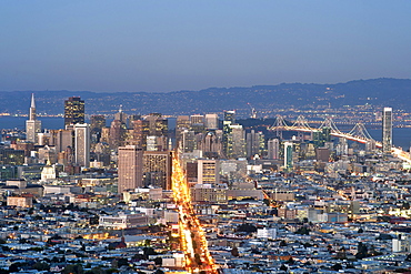 Dusk view of San Francisco, Market Street and the Oakland Bay Bridge from the summit of Twin Peaks, San Francisco, California, United States of America, North America