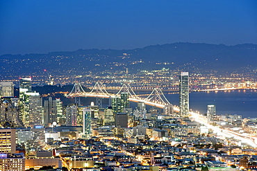 Dusk view of San Francisco and the Oakland Bay Bridge from the summit of Twin Peaks in California, United States of America, North America