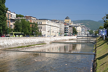 Buildings along Obala Kulina Bana road on the north bank of the Miljacka River in Sarajevo, capital of Bosnia and Herzegovina, Europe