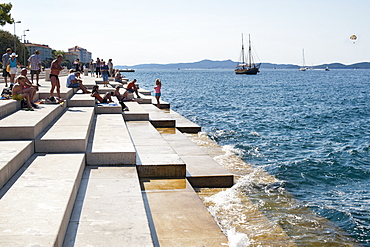 People on the steps of the Sea Organ in Zadar on the Adriatic coast, Croatia, Europe