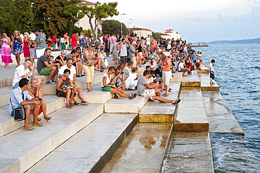 People on the steps of the Sea Organ in Zadar on the Adriatic coast, Croatia, Europe