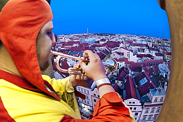 The Prague Trumpeter playing his tune from the Old Town Tower in Prague, Czech Republic, Europe