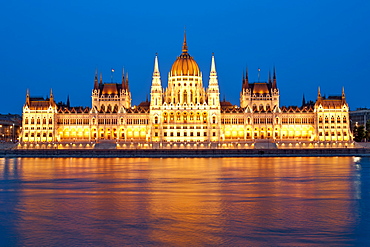 Dusk view of the Hungarian Parliament Building on the banks of the Danube River, Budapest, Hungary, Europe