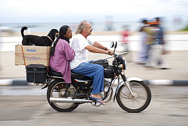 Motorcyclist and passengers on the Pondicherry waterfront in India