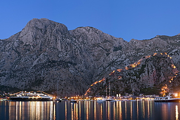 Dusk view of Kotor Bay, Kotor town and the fortifications overlooking the town, UNESCO World Heritage Site, Montenegro, Europe