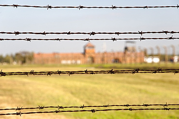 Barbed-wire fencing and buildings at the museum of the former Auschwitz II-Birkenau concentration camp, UNESCO World Heritage Site, southern Poland, Europe