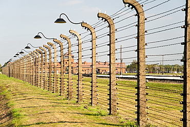 Electrified barbed-wire fencing and buildings at the museum of the former Auschwitz I-Birkenau concentration camp, UNESCO World Heritage Site, Poland, Europe