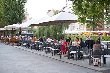 Sidewalk cafes on the banks of the Ljubljanica River in the old town in Ljubljana, Slovenia, Europe