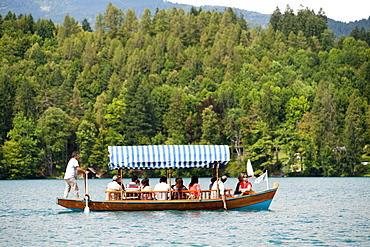 Tourists on a boat in Lake Bled in the Julian Alps in northwest Slovenia, Europe