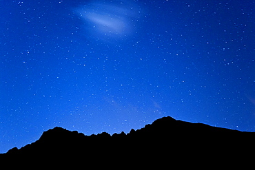 Stars over the mountain peaks encircling the Cirque de Cilaos caldera on the French island of Reunion in the Indian Ocean, Africa