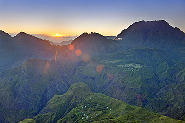 The sun rising over the Cirque de Mafate caldera on the French island of Reunion in the Indian Ocean, Africa