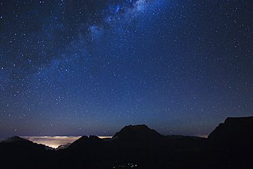 The Milky Way over the mountains encircling the Cirque de Mafate caldera on the French island of Reunion in the Indian Ocean, Africa