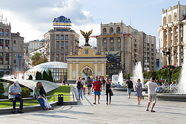 Pecerskyj gate and pedestrians in Independence Square (Maidan Nezalezhnosti) in Kiev, the capital of Ukraine, Europe