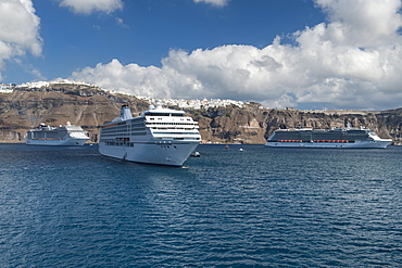 View of the village of Fira and cruise ships anchored off the coast of the Greek island of Santorini, Cyclades, Greek Islands, Greece, Europe