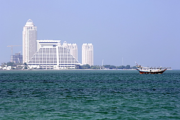 The Sheraton hotel on west bay and a ship in the bay in Doha in Qatar.