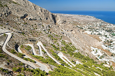 The winding road leading from Kamari to the ruins of Ancient Thira on Messavouno mountain on the Greek island of Santorini, Cyclades, Greek Islands, Greece, Europe