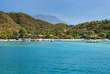 Padang Bai beach and the peak of Mount Agung on the island of Bali, Indonesia.