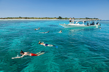 Tourist boat with snorkelers off the coast of Gili Air island in Indonesia.