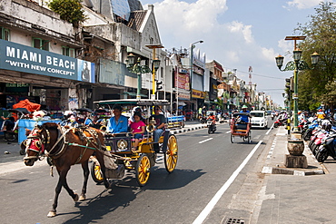 Horse drawn carriage on Jalan Malioboro, one of the main avenues in Yogyakarta, Java, Indonesia.