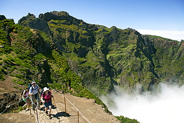 Hikers on the Pico de Areiero trail in Madeira. Pico de Areiero is the highest peak in Madeira at 1818 metres.