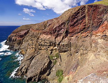 Coastal landscape at Ponta do Gabriel on the Portuguese Atlantic island of Porto Santo. The mountainside has slid away revealing signs of volcanic activity.