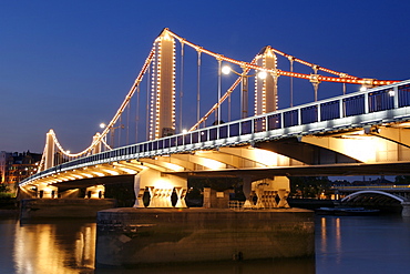 Dusk view of Chelsea Bridge which spans the Thames River in London.