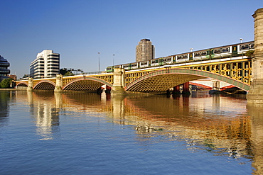 Early morning view of Blackfriars rail bridge spanning the Thames River in London. Photographed from the north bank looking west.