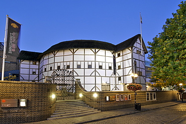 Dusk view of Shakespeare's Globe theatre on the banks of the Thames river in London.