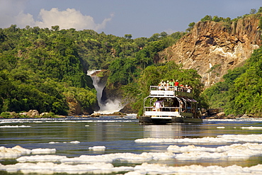 A tourist boat at Murchison Falls waterfall on the Victoria Nile River in Murchison Falls National Park in Uganda.