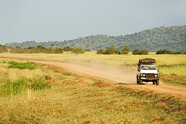 Land Rover Defender driving through the Kabwoya Wildlife Reserve in western Uganda.