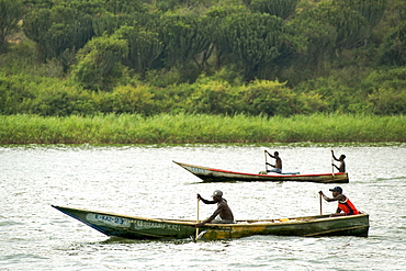 Ugandans in fishing boats on the Kazinga channel that leads between Lake George and Lake Edward in the Queen Elizabeth National Park in western Uganda.