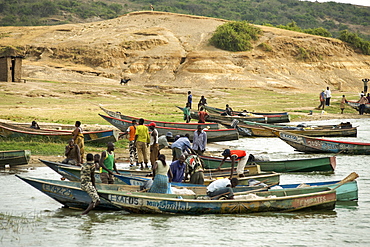 Ugandan villagers along the bank of the Kazinga channel that leads between Lake George and Lake Edward in the Queen Elizabeth National Park in western Uganda.