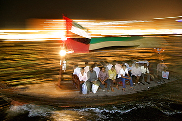 Passengers on an abra water taxi on the Dubai creek in Dubai in the UAE.