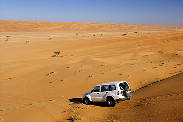 4WD in the dunes of Wahiba Sands (Ramlat al Wahaybah) in Oman.