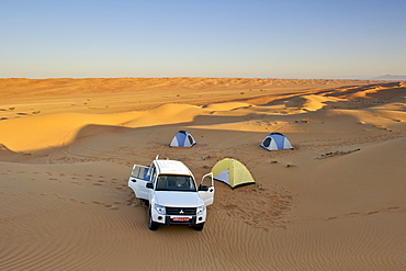 4WD and tents in Wahiba sands in Oman.