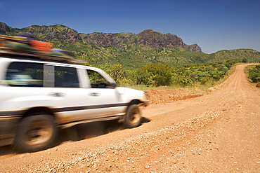 Land Cruiser driving on a dirt road near the village of Nakapiripirit at the foot of the Debasien mountains in the Nakapiripirit region of eastern Uganda.