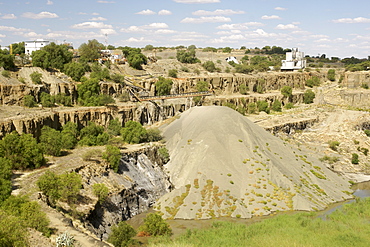 The De Beers diamond mine in Kimberley South Africa being filled with re-processed mine dump tailings from the De Beers combined treatment plant (CTP).