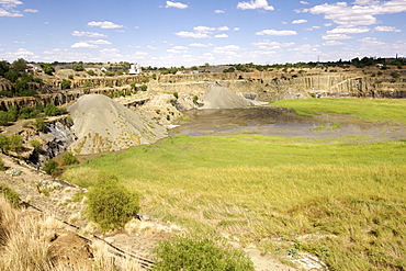 The De Beers diamond mine in Kimberley South Africa being filled with re-processed mine dump tailings from the De Beers combined treatment plant (CTP).