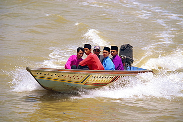 A group of men in a water taxi crossing the Brunei River in Bandar Seri Begawan, in Brunei Darussalam, Borneo, Southeast Asia, Asia