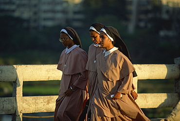 Nuns crossing the Mula River, Pune, Maharashtra state, India, Asia