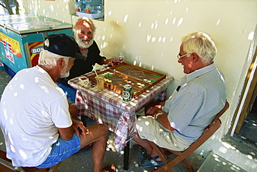 Elderly men playing backgammon in Siana, Rhodes, Dodecanese, Greek Islands, Greece, Europe