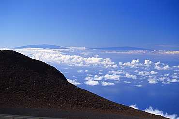 The two great 13000ft volcanic peaks of Mauna Loa on right, and Mauna Kea on the Big Island seen from the top of the Haleakala volcano, Maui, Hawaii, Hawaiian Islands, United States of America, Pacific, North America