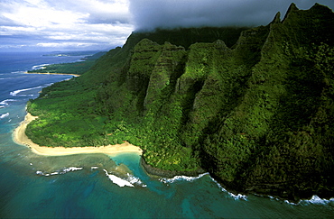 The towering eroded seacliffs of the famous NA PALI COAST ending at lovely Kee Beach, a favourite with snorkellers and film-makers, Kauai, Hawaii, USA